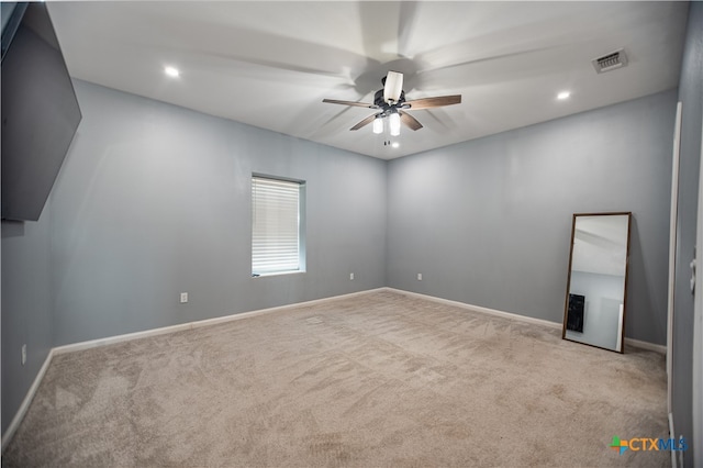 carpeted empty room with ceiling fan