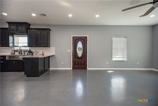 kitchen featuring concrete flooring, sink, and ceiling fan