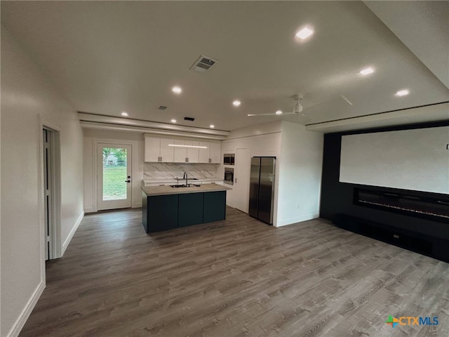kitchen with a sink, light countertops, appliances with stainless steel finishes, visible vents, and recessed lighting
