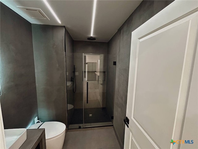 bathroom featuring visible vents, toilet, a stall shower, and vanity