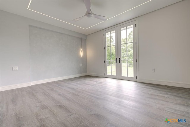 3104 Zephyr Rd, Killeen, TX 76543 - spare room featuring french doors, ceiling fan, wood finished floors, and baseboards