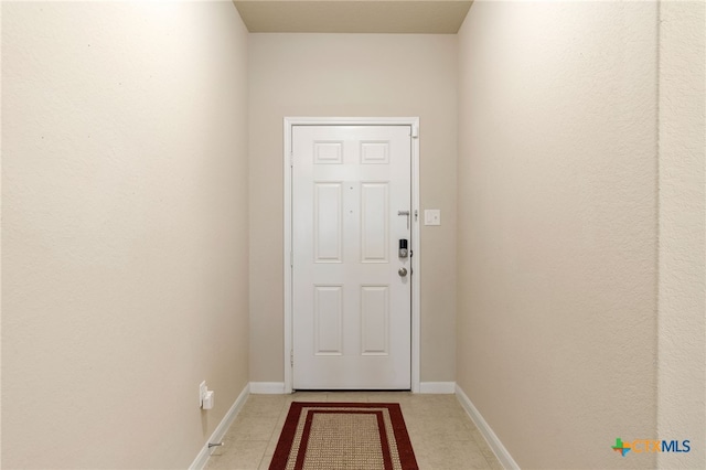 doorway to outside featuring tile patterned flooring