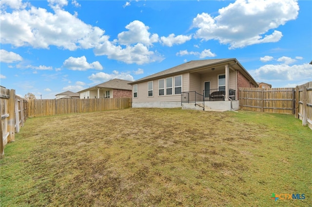 rear view of house with a yard