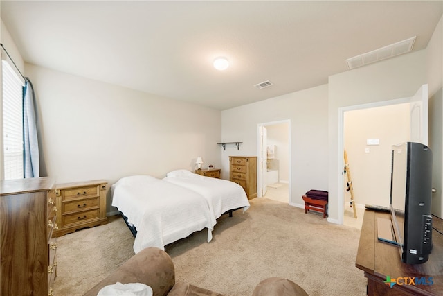 carpeted bedroom with connected bathroom