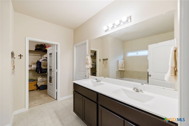 bathroom with a washtub and vanity