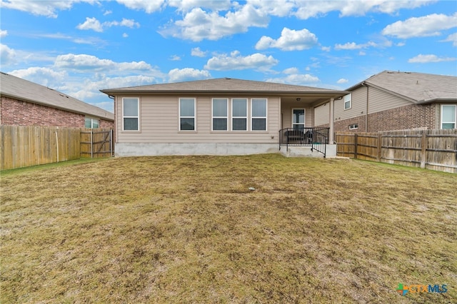 rear view of property with a yard