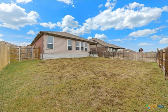 rear view of property featuring a lawn