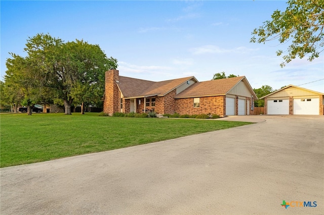 151 Crest Circle Dr, San Marcos, TX 78666 - view of front of property with a chimney, a detached garage, a front yard, and brick siding