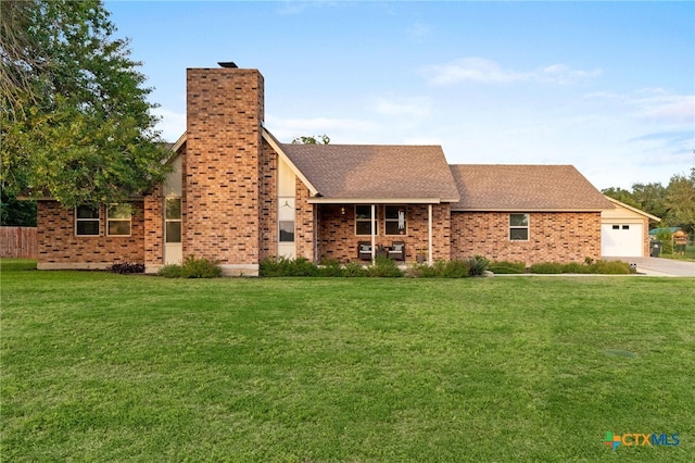 151 Crest Circle Dr, San Marcos, TX 78666 - view of front facade with a front lawn, a chimney, an attached garage, and driveway