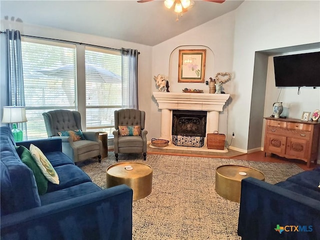 living room with ceiling fan, a healthy amount of sunlight, and vaulted ceiling