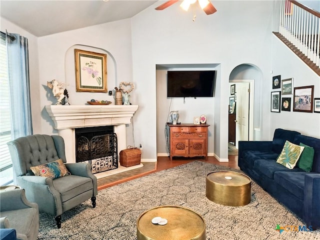 living room featuring hardwood / wood-style flooring, ceiling fan, high vaulted ceiling, and a wealth of natural light