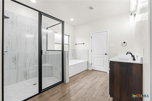 bathroom with vanity and independent shower and bath