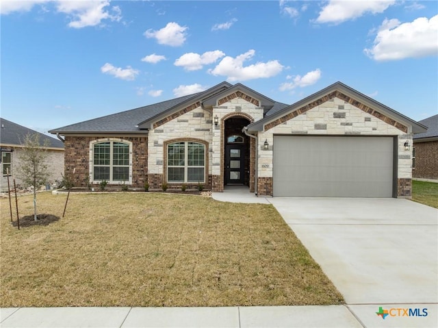 view of front of house with a garage and a front yard