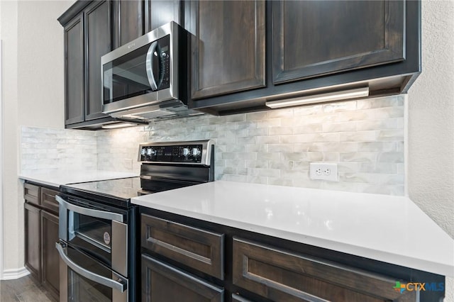 kitchen featuring dark brown cabinetry, hardwood / wood-style floors, and stainless steel appliances