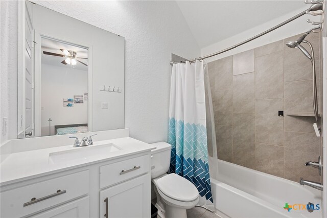 bathroom featuring a ceiling fan, toilet, shower / tub combo, and vanity
