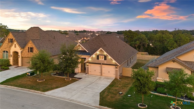 view of front facade featuring driveway, metal roof, a standing seam roof, and a yard