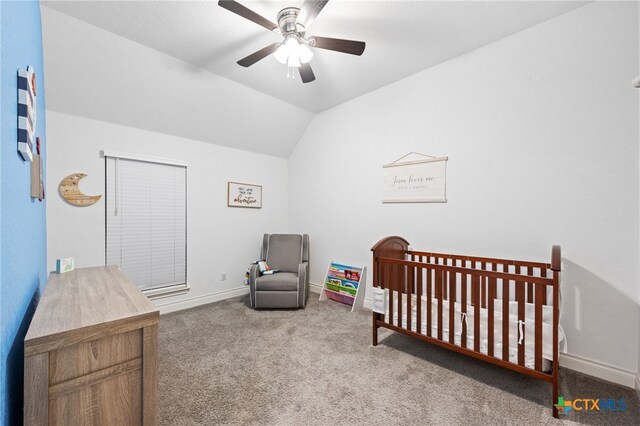 carpeted bedroom with baseboards, lofted ceiling, a ceiling fan, and a nursery area
