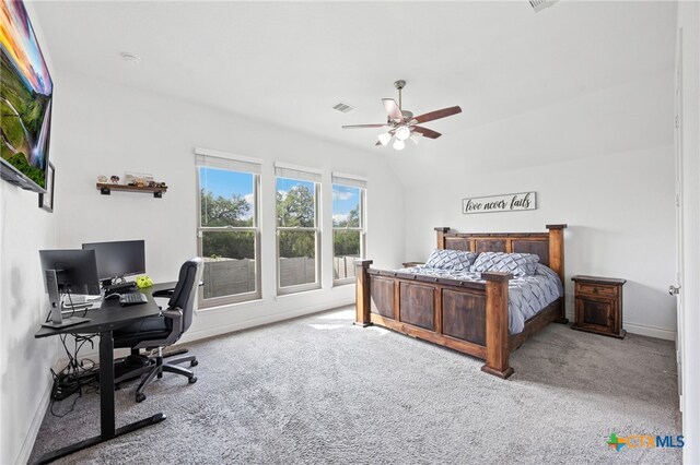 carpeted bedroom featuring a ceiling fan, baseboards, vaulted ceiling, and visible vents