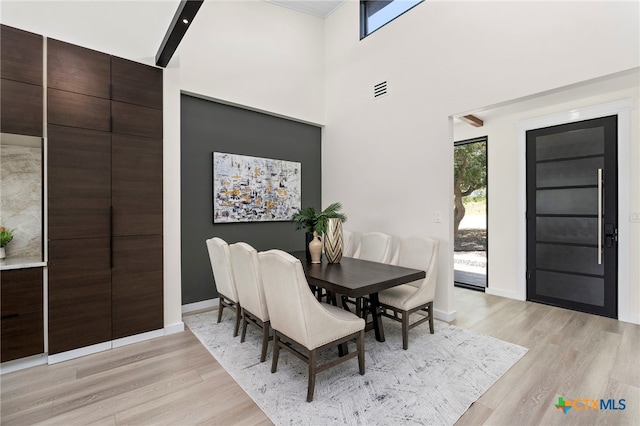 2637 Campestres, Spring Branch, TX 78070 - dining space featuring light wood finished floors, healthy amount of natural light, baseboards, and a towering ceiling