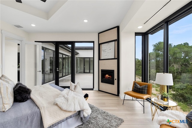 2637 Campestres, Spring Branch, TX 78070 - bedroom with access to outside, light wood-type flooring, recessed lighting, a fireplace, and floor to ceiling windows