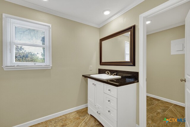 bathroom with crown molding and vanity