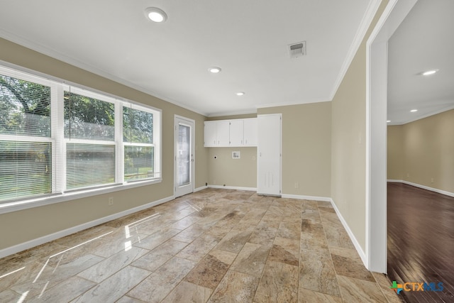 empty room featuring crown molding