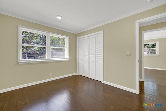 unfurnished bedroom featuring multiple windows, dark wood-type flooring, and ornamental molding