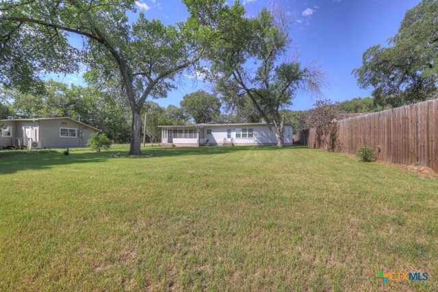 ranch-style home featuring a front lawn and a sunroom