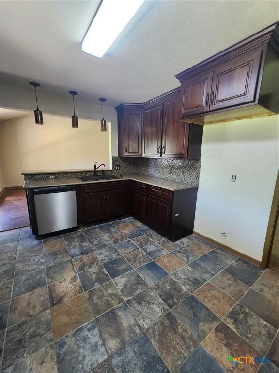 kitchen with dark brown cabinetry, sink, decorative light fixtures, dishwasher, and backsplash