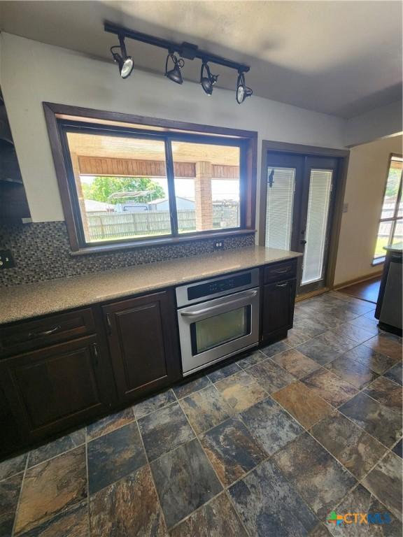 kitchen with tasteful backsplash, oven, and french doors