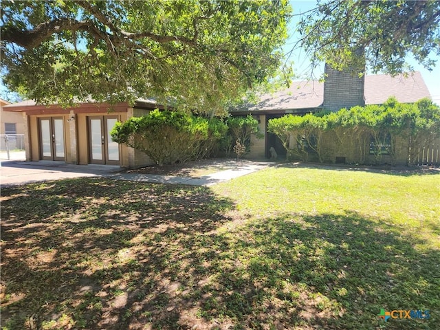 view of yard with french doors