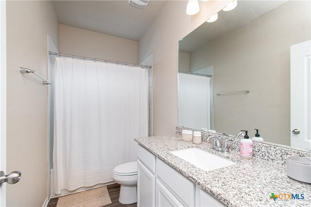10207 Six Shooter Ln, Temple, TX 76502 - bathroom featuring toilet, vanity, and wood finished floors