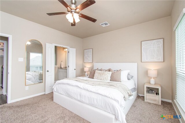 10207 Six Shooter Ln, Temple, TX 76502 - bedroom featuring carpet floors, baseboards, arched walkways, and ensuite bathroom