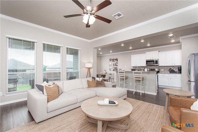 10207 Six Shooter Ln, Temple, TX 76502 - living room featuring ornamental molding, dark wood finished floors, a ceiling fan, baseboards, and recessed lighting