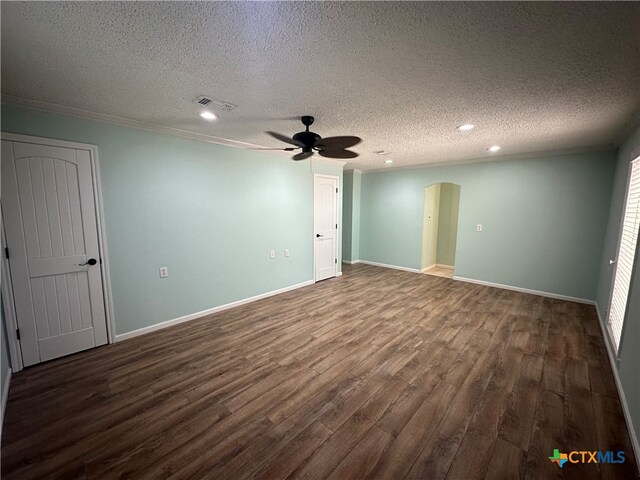 spare room with ornamental molding, ceiling fan, a textured ceiling, and dark hardwood / wood-style floors