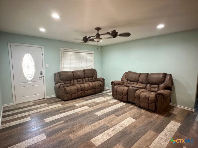 living room with dark hardwood / wood-style floors and ceiling fan