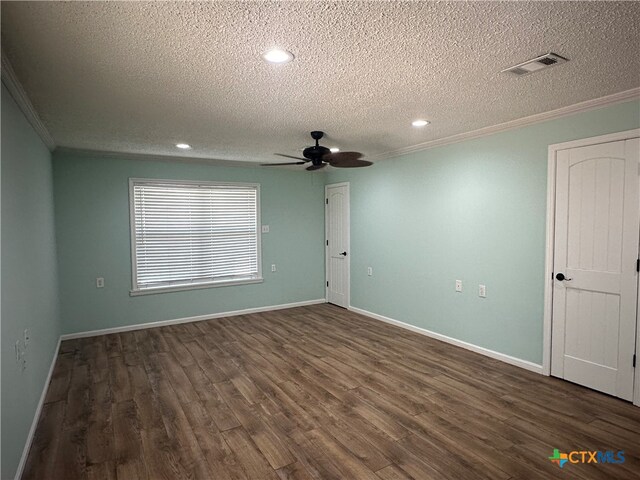 empty room with dark hardwood / wood-style flooring, a textured ceiling, ceiling fan, and crown molding