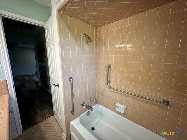 bathroom featuring tiled shower / bath combo and tile patterned floors