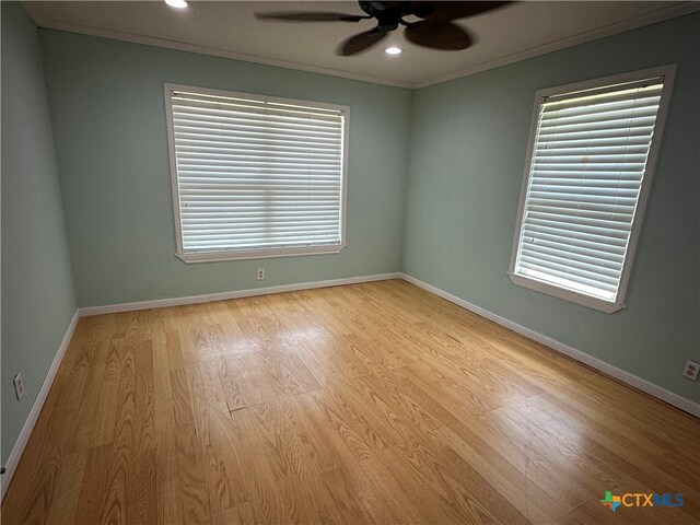 empty room with light hardwood / wood-style floors, ceiling fan, and crown molding