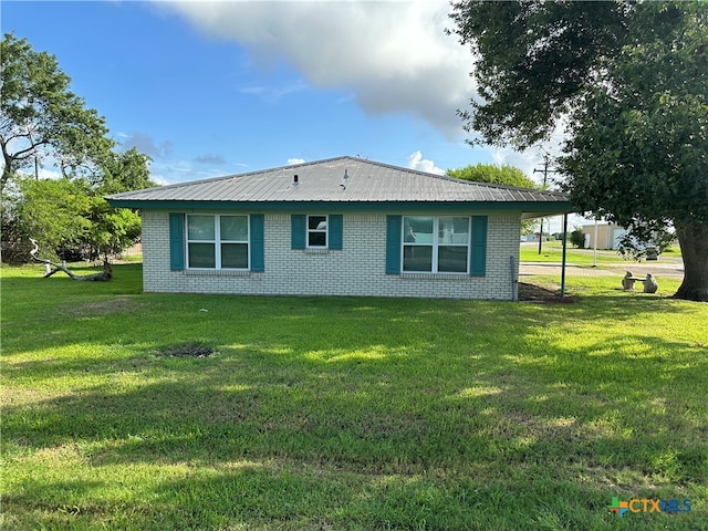 view of side of home with a lawn