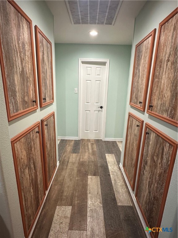 hallway featuring dark hardwood / wood-style flooring