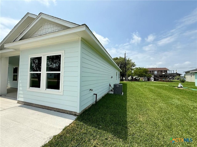 view of home's exterior featuring a lawn, a patio area, and central air condition unit
