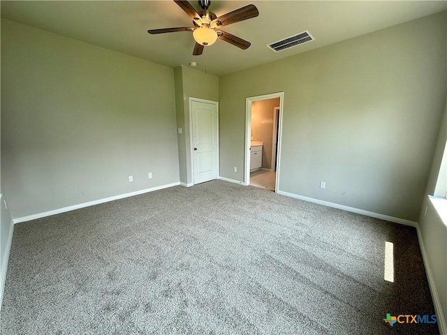 unfurnished bedroom featuring a ceiling fan, visible vents, carpet, baseboards, and ensuite bathroom