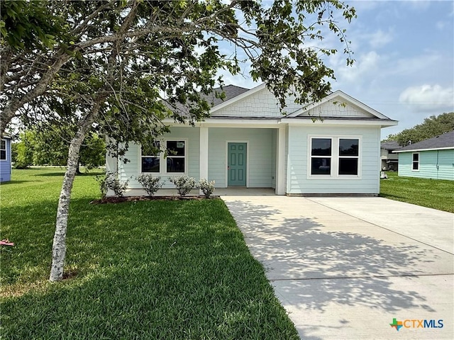 view of front of property with covered porch, concrete driveway, and a front yard