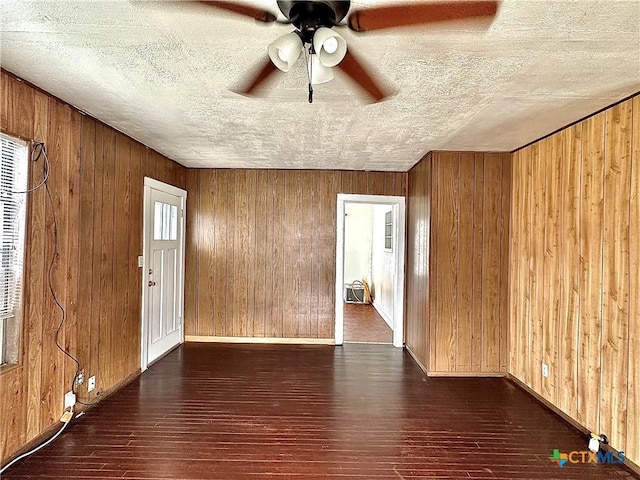 spare room with wood walls and hardwood / wood-style flooring