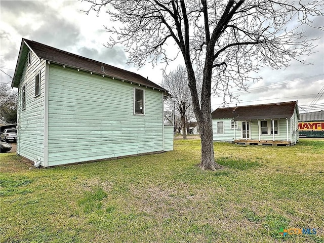 view of side of home with a lawn