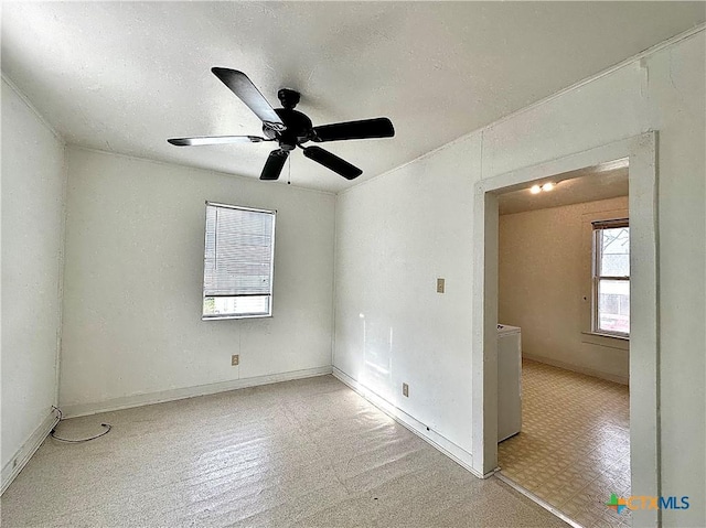 spare room featuring a ceiling fan and a textured ceiling