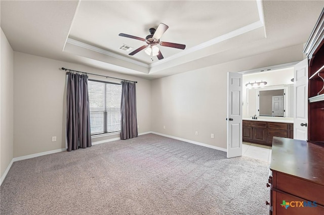 519 Gianotti Ct, Temple, TX 76502 - unfurnished bedroom featuring a tray ceiling, crown molding, light colored carpet, ensuite bathroom, and a ceiling fan