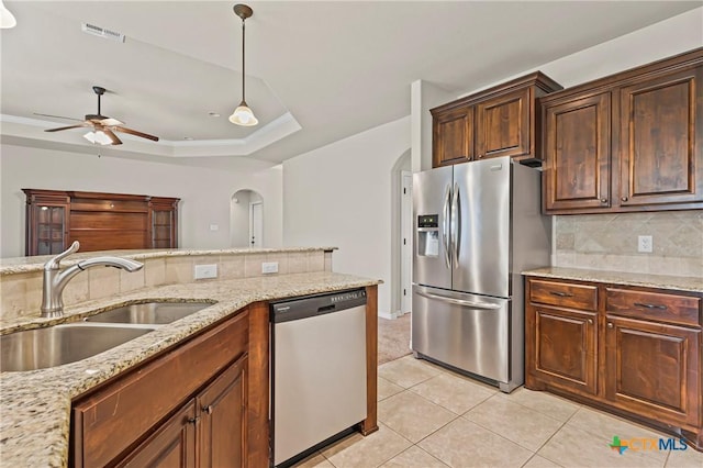 519 Gianotti Ct, Temple, TX 76502 - kitchen with stainless steel appliances, arched walkways, decorative backsplash, light tile patterned floors, and a ceiling fan