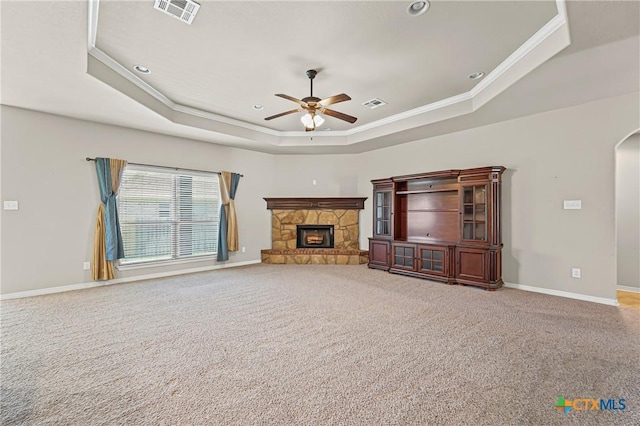 519 Gianotti Ct, Temple, TX 76502 - unfurnished living room with a tray ceiling, crown molding, ceiling fan, carpet floors, and a stone fireplace